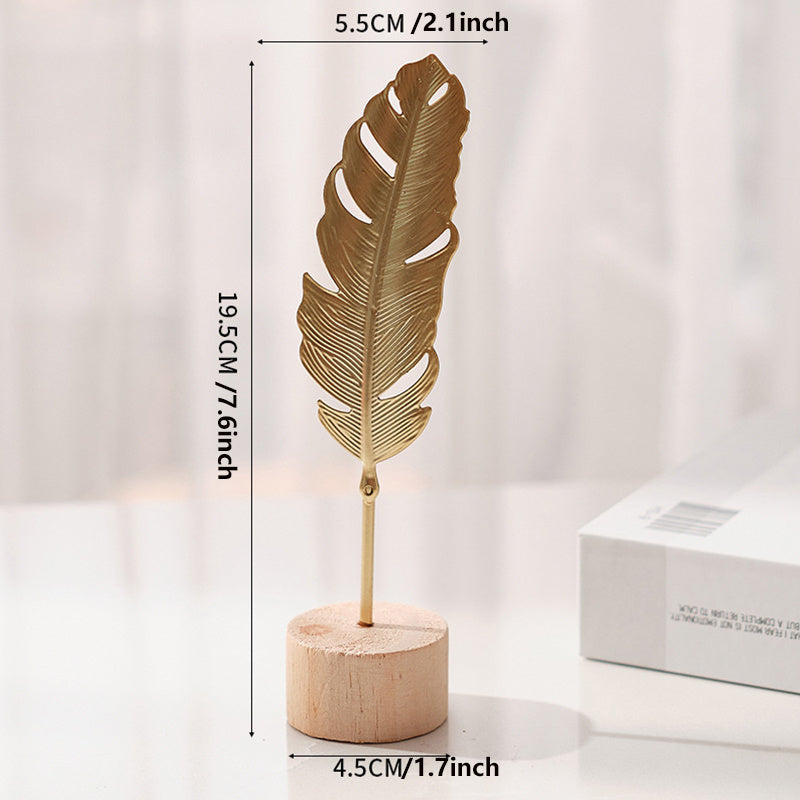 Sculpture with leaf motif in metal on wooden base for indoor use