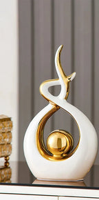 Abstract decorative figure in ceramic with gold finish