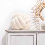Round decorative pillow with knotted design