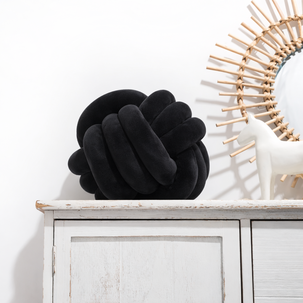 Round decorative pillow with knotted design