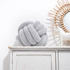 Round decorative pillow with knotted design