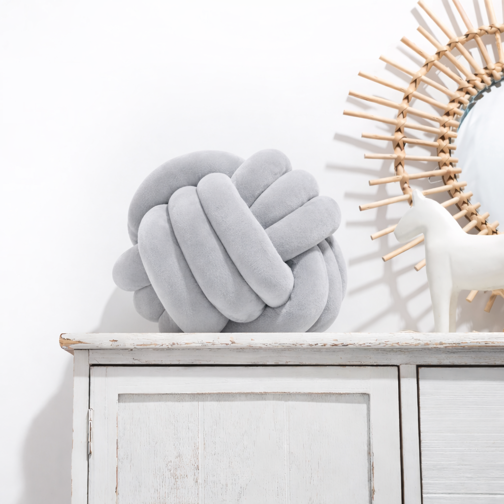 Round decorative pillow with knotted design