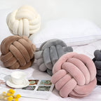 Round decorative pillow with knotted design