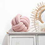 Round decorative pillow with knotted design