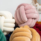 Round decorative pillow with knotted design