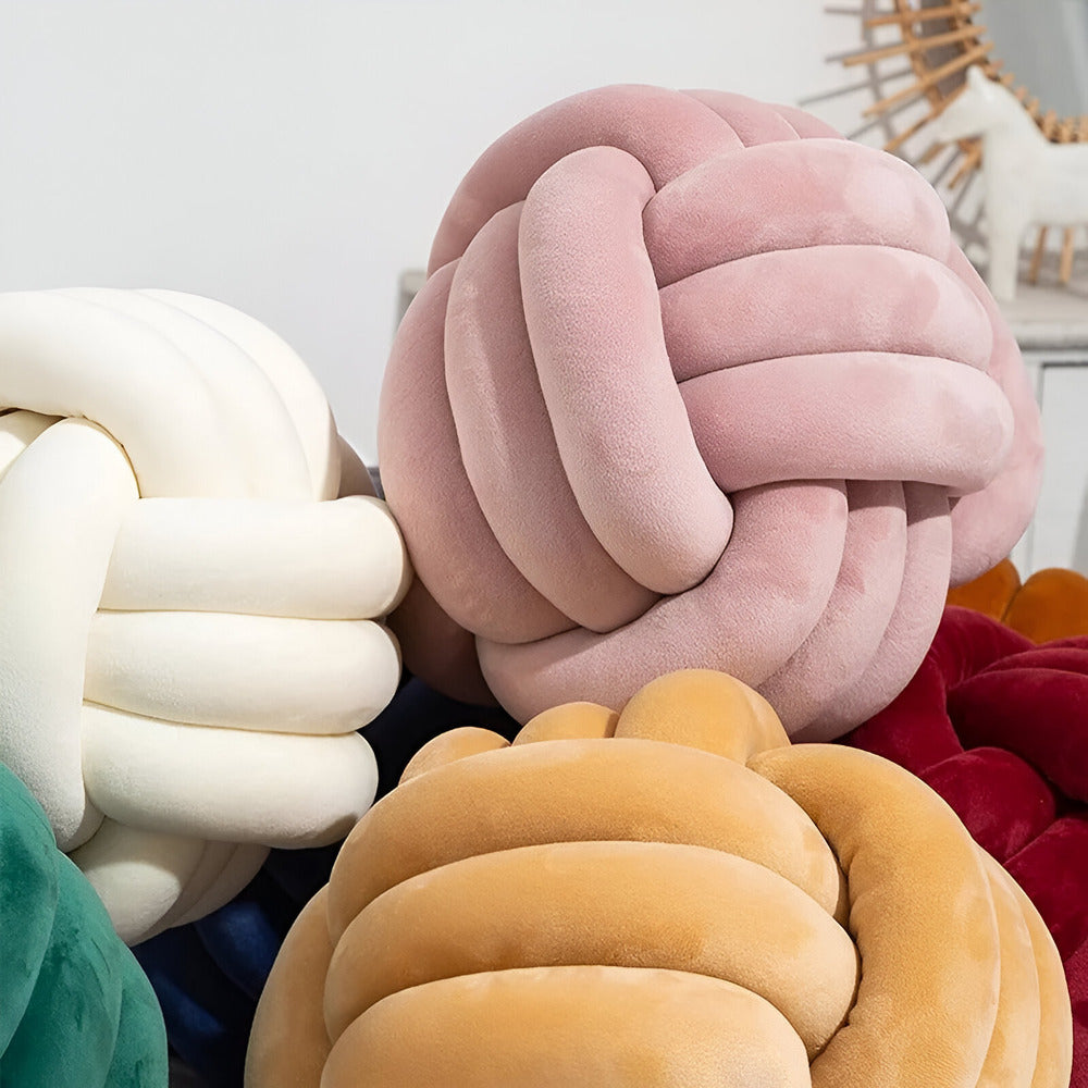 Round decorative pillow with knotted design