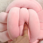 Round decorative pillow with knotted design