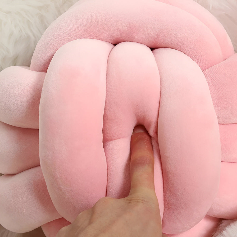 Round decorative pillow with knotted design