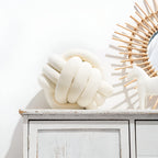 Round decorative pillow with knotted design