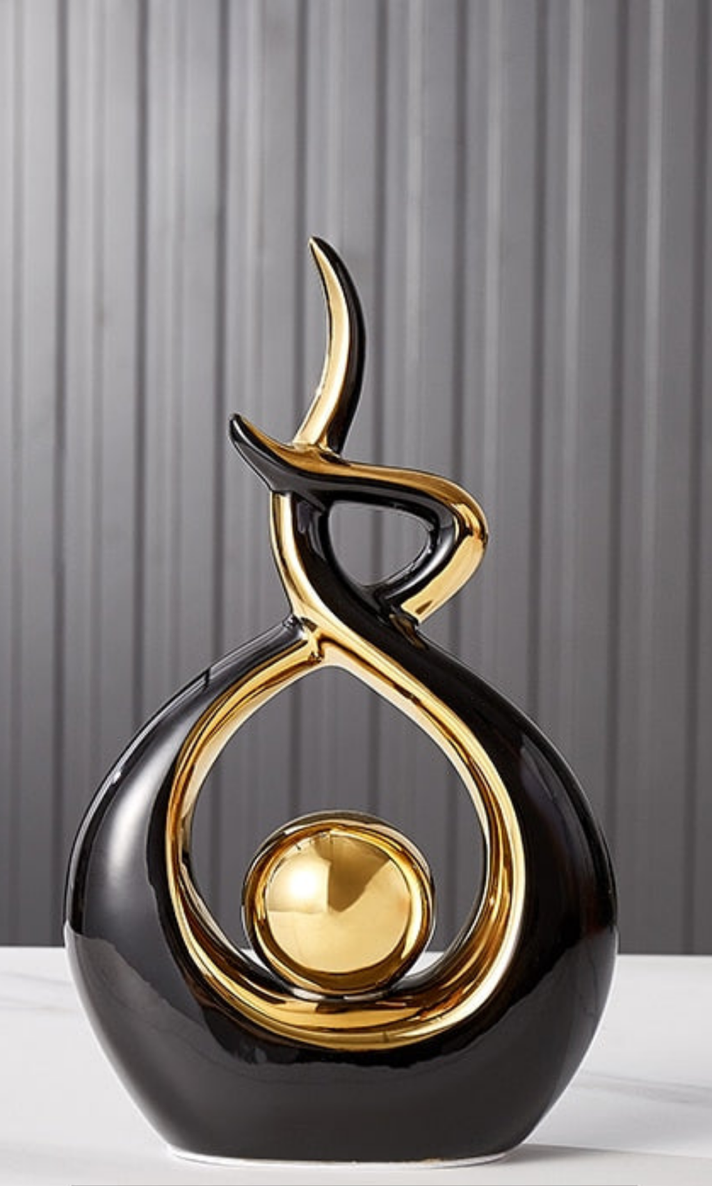 Abstract decorative figure in ceramic with gold finish