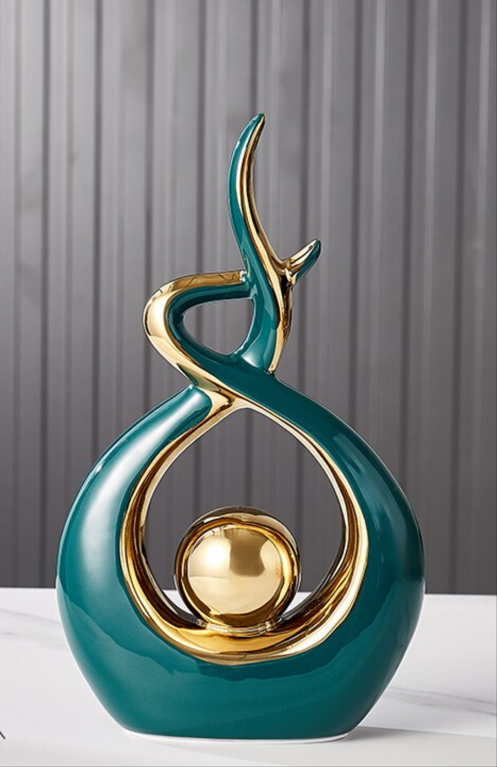 Abstract decorative figure in ceramic with gold finish