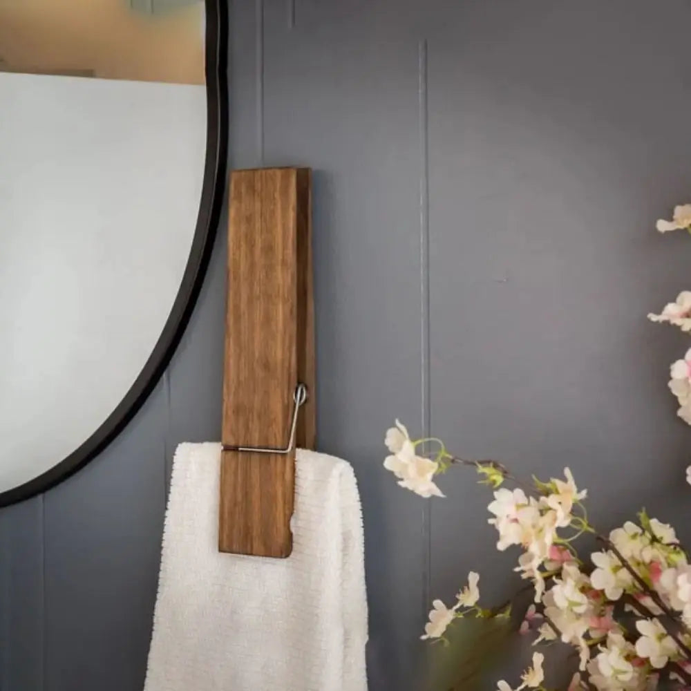 Towel holder shaped like a clothespin in wood