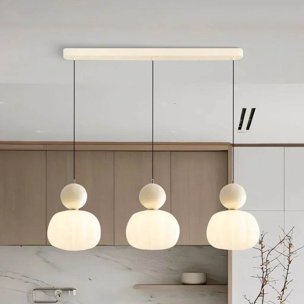 Pendant lamp with glass globe and decorative top for indoor use