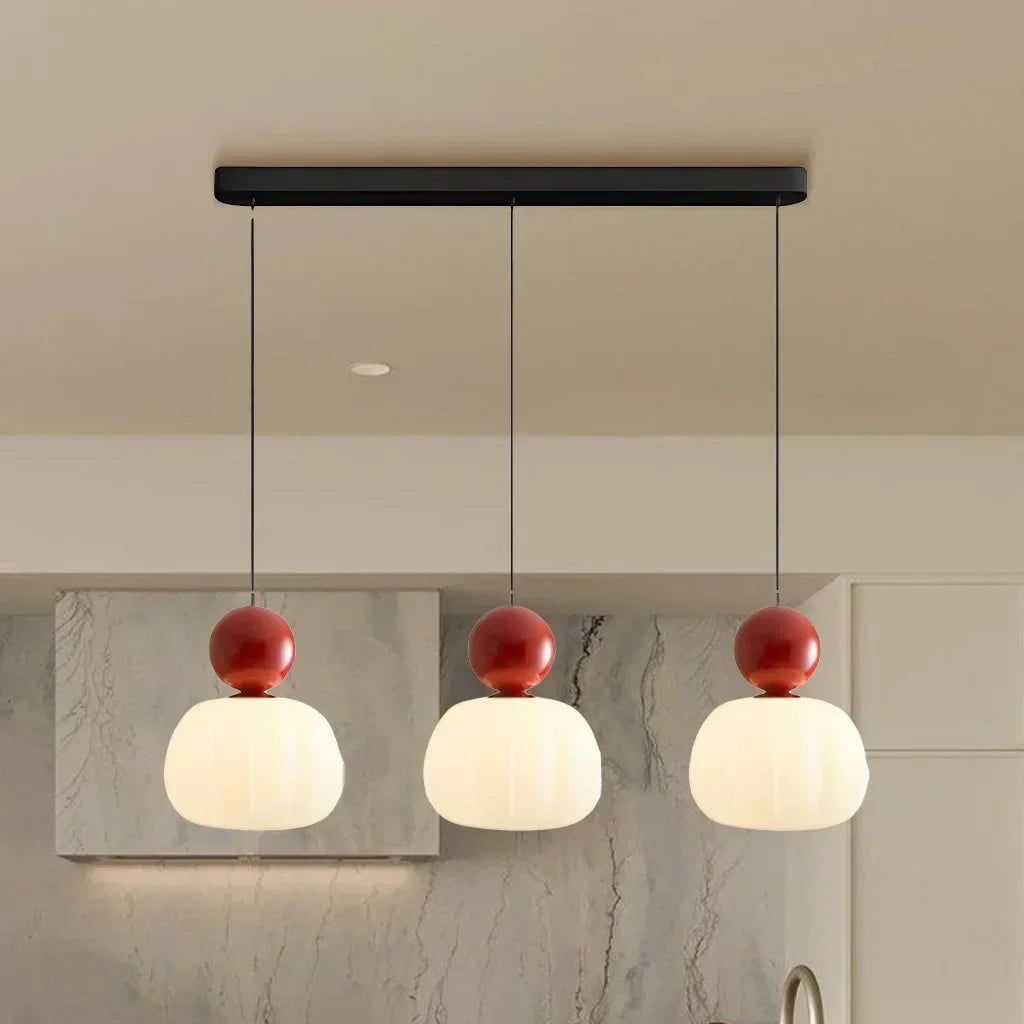 Pendant lamp with glass globe and decorative top for indoor use