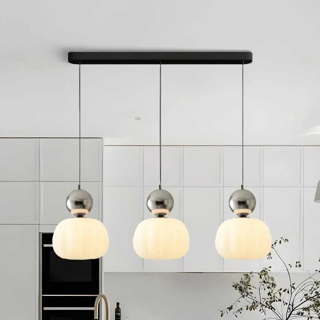 Pendant lamp with glass globe and decorative top for indoor use