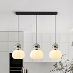 Pendant lamp with glass globe and decorative top for indoor use