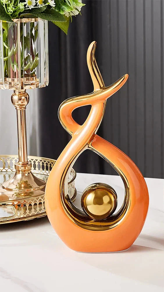 Abstract decorative figure in ceramic with gold finish