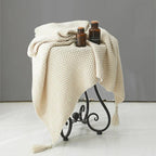 Warm home textiles for sofa and relaxation – Wool blanket with tassels